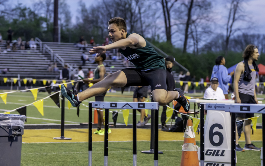 boy jumping hurdles